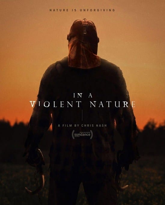 The official movie poster for the 2024 horror film In A Violent Nature. A massive, hulking figure stands with his back to the camera, silhouetted against an amber, sunset-lit sky. He wears a ragged, vintage firefighter's mask and dirty gear, gripping two rusted logging drag hooks attached to chains in his hands. The tagline at the top reads "NATURE IS UNFORGIVING," with the title "IN A VIOLENT NATURE" centered below in white serif text.