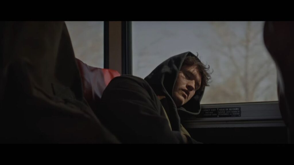 Billy (Rohan Campbell) sleeping on a bus during a scene from the Silent Night, Deadly Night (2025) remake.
