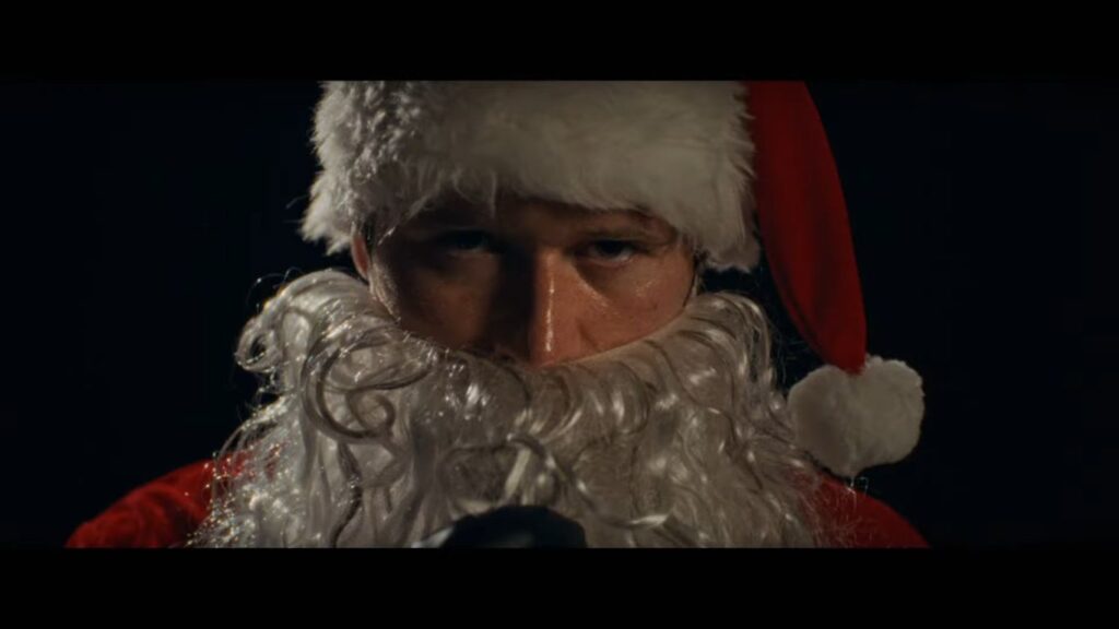 A menacing close-up of the Santa Claus killer staring intensely in Silent Night, Deadly Night (2025).