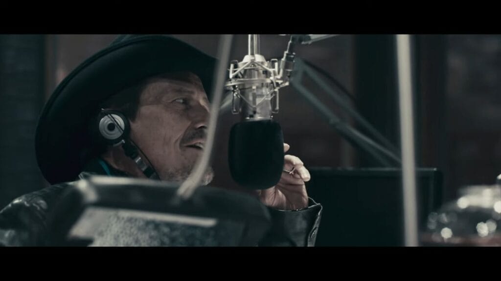 Stephen McHattie as Grant Mazzy speaking into a microphone in a radio booth, a key scene for understanding the Pontypool (2008) Ending Explained.