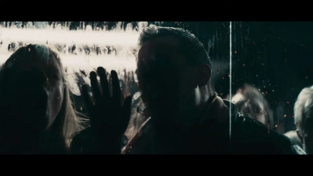 Silhouettes of infected people pressing against the glass of the radio booth, a tense scene analyzed in the Pontypool (2008) Ending Explained.
