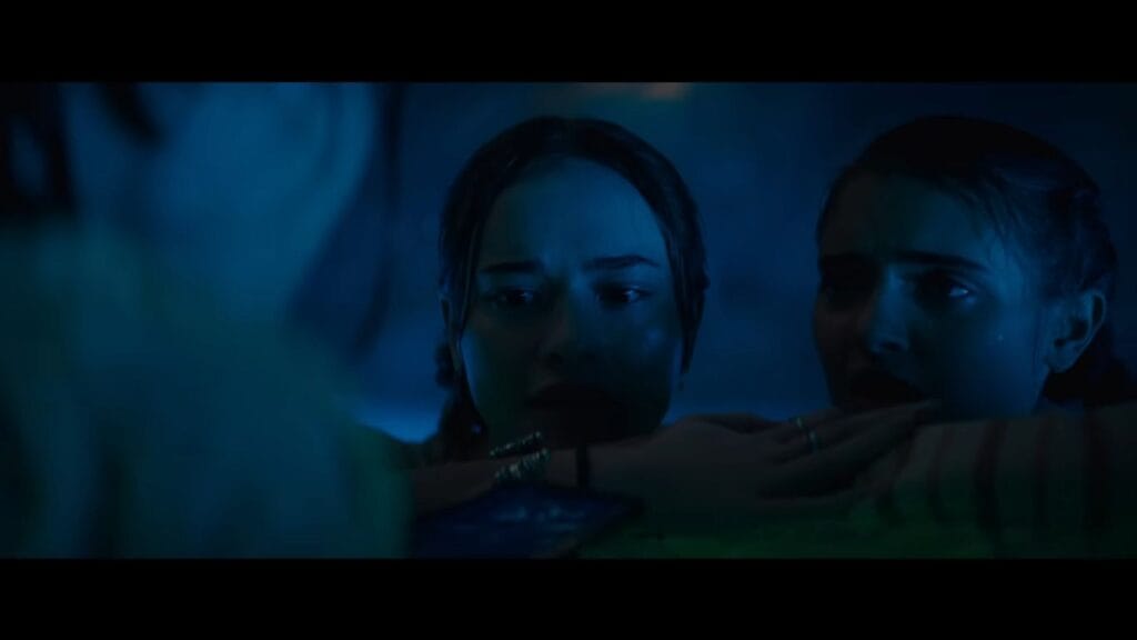 Two characters look on in shock during the middle of Primate (2025).