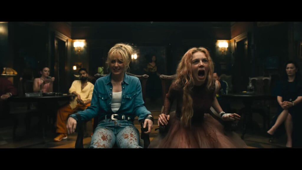 Grace (Samara Weaving) and Faith (Kathryn Newton) are tied to chairs in a tense confrontation scene from the Ready or Not 2: Here I Come movie review.