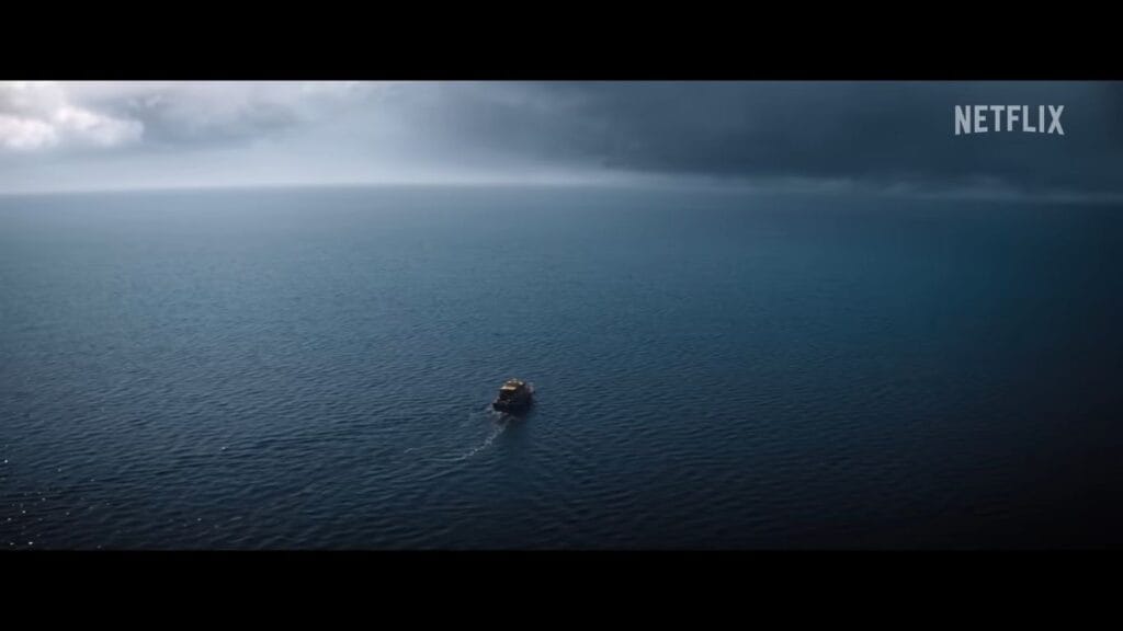 A small boat traveling across a vast, dark blue ocean under a stormy sky in a scene from Thrash.