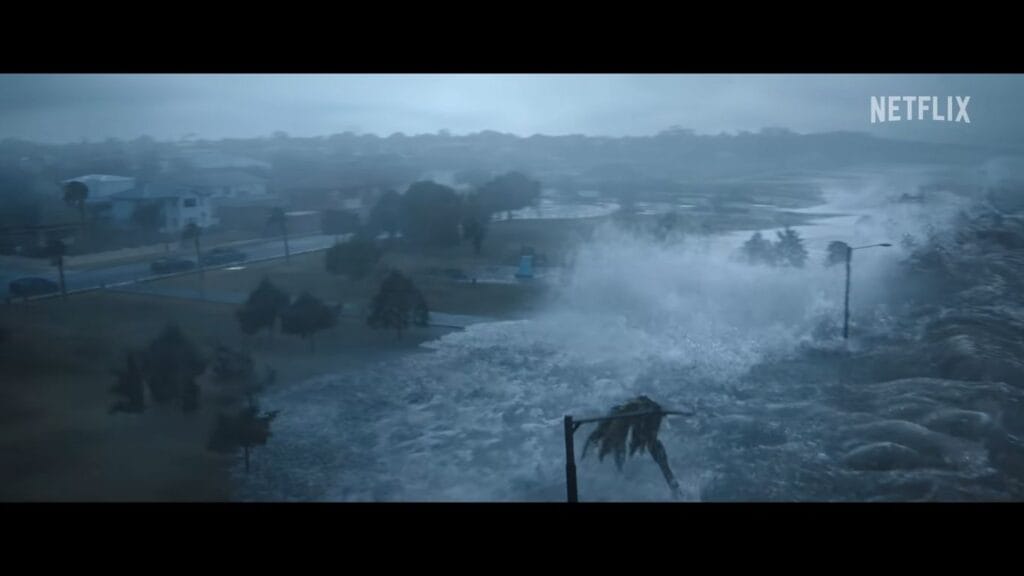 A massive storm surge and crashing waves flooding a coastal residential neighborhood during a hurricane.