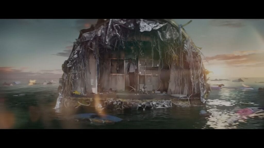 The severed tail section of a wrecked commercial airplane floating on calm ocean water with wires hanging loose during a sunset survival scene.