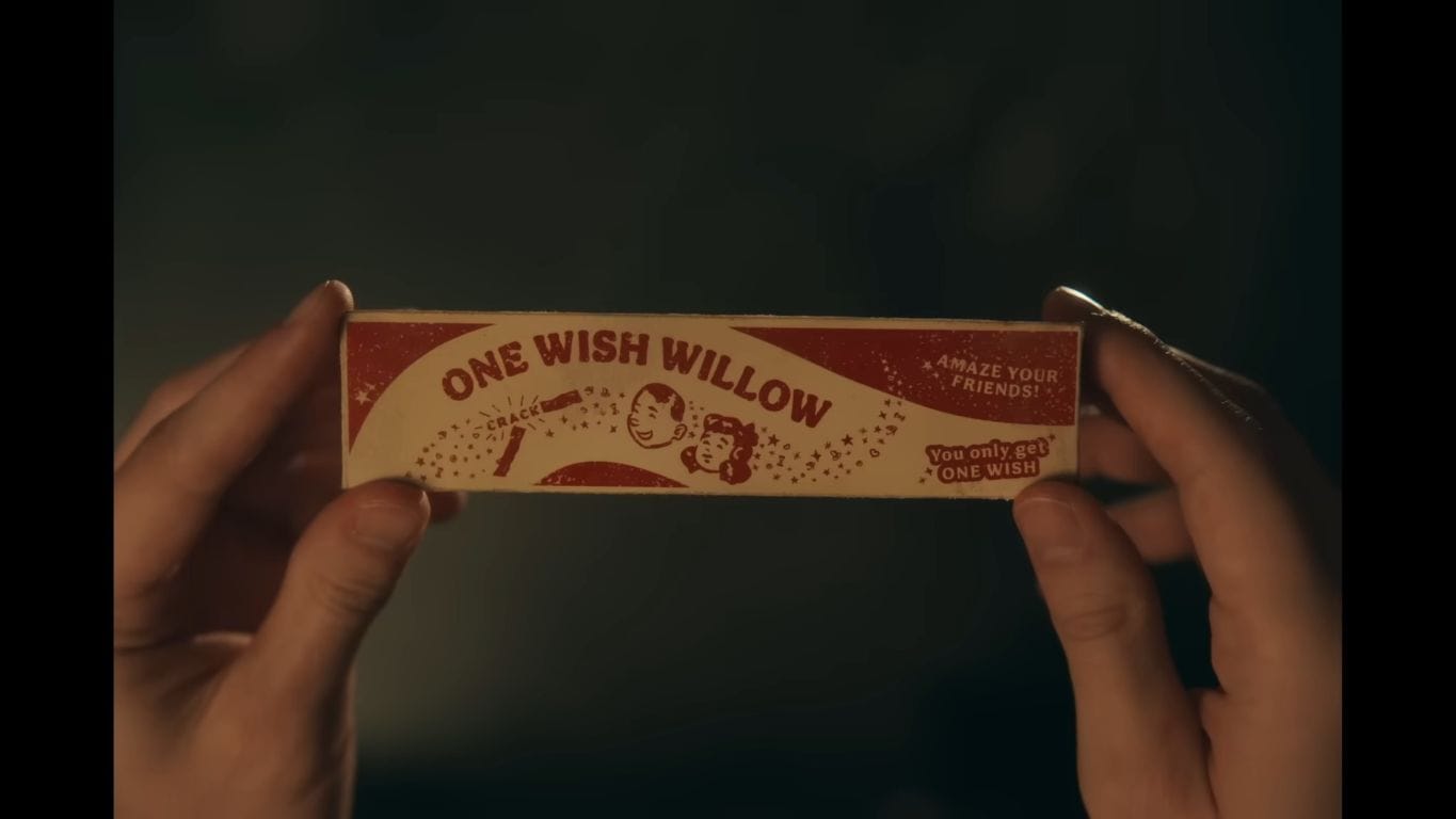 Hands holding a vintage box for One Wish Willow, with text saying Amaze your friends! and You only get one wish