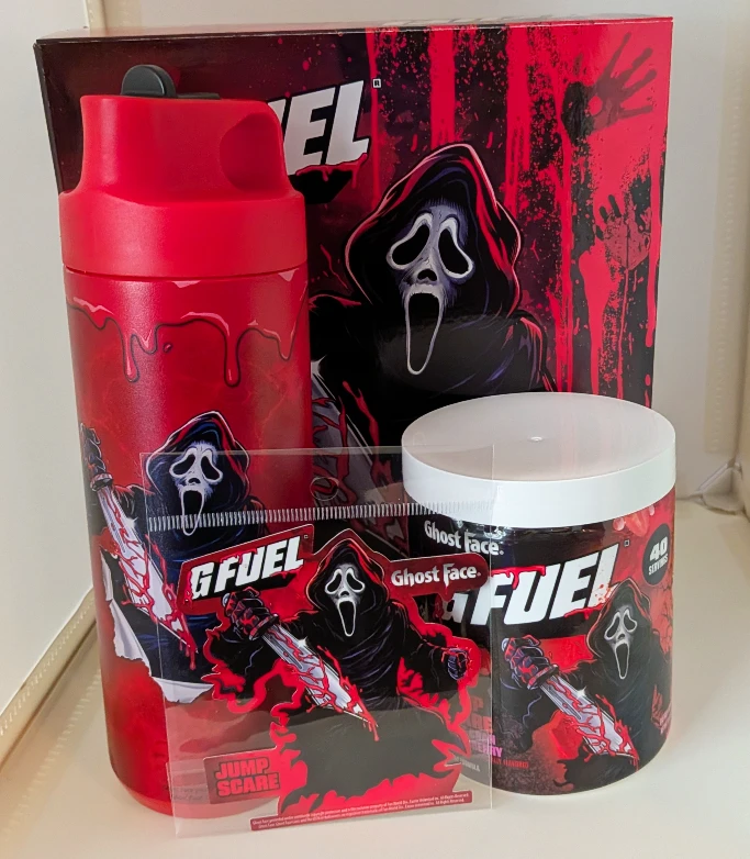 G Fuel Ghost Face Jump Scare collector's box set showcasing the steel shaker cup, a tub of energy formula, and a character sticker.