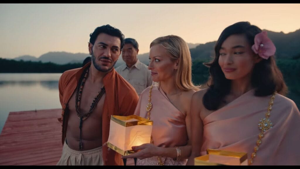 Francesca Eastwood and Dani Oliveros wearing traditional silk garments while holding glowing paper lanterns on a dock in the horror movie The Bay.