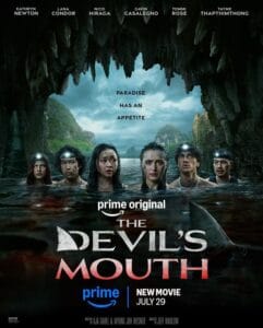 Official Prime Original movie poster for The Devil's Mouth showing six actors wading in bloody water inside a cave with a shark fin lurking nearby under the tagline Paradise Has An Appetite.