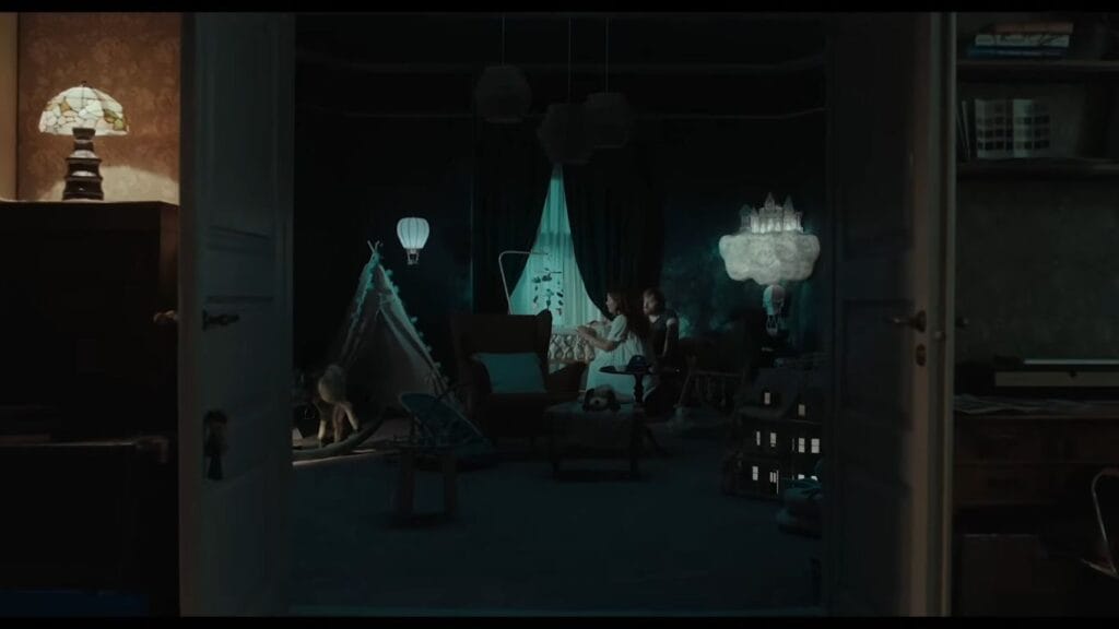 A dimly lit nursery room viewed through double doors featuring atmospheric decorations, a crib, and a dollhouse in Nightborn.