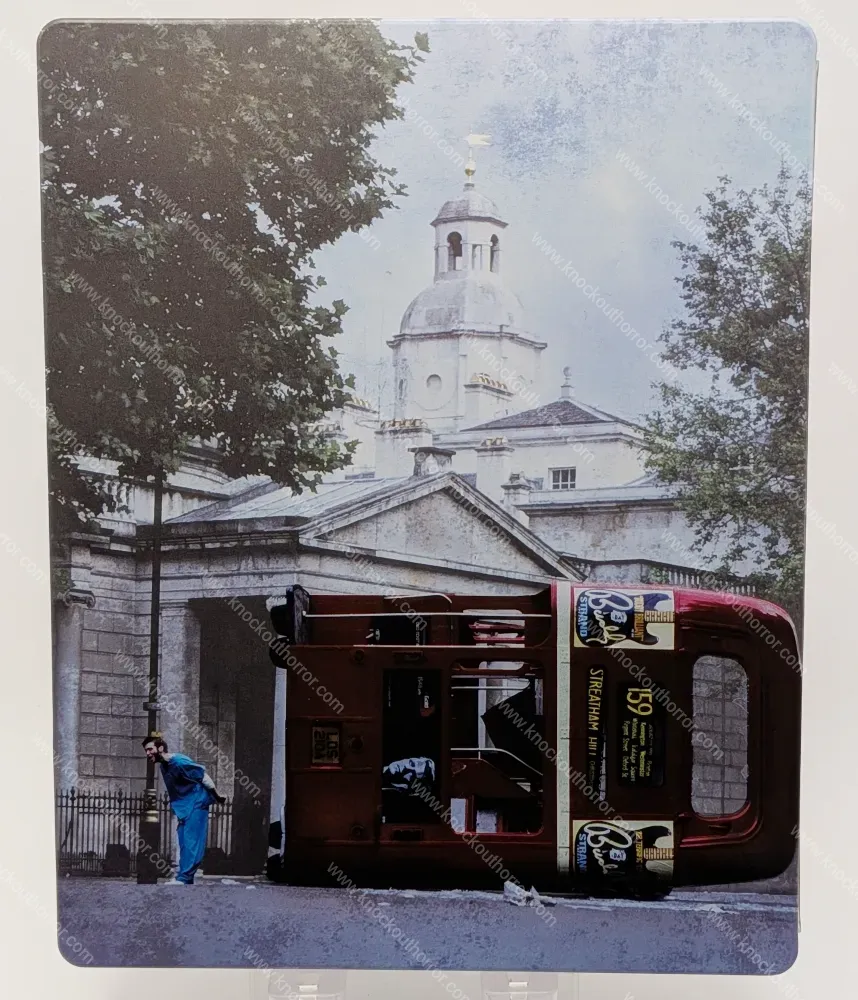 Rear cover of the 28 Days Later 4K steelbook showing Jim in hospital scrubs standing next to an overturned red London double-decker bus.