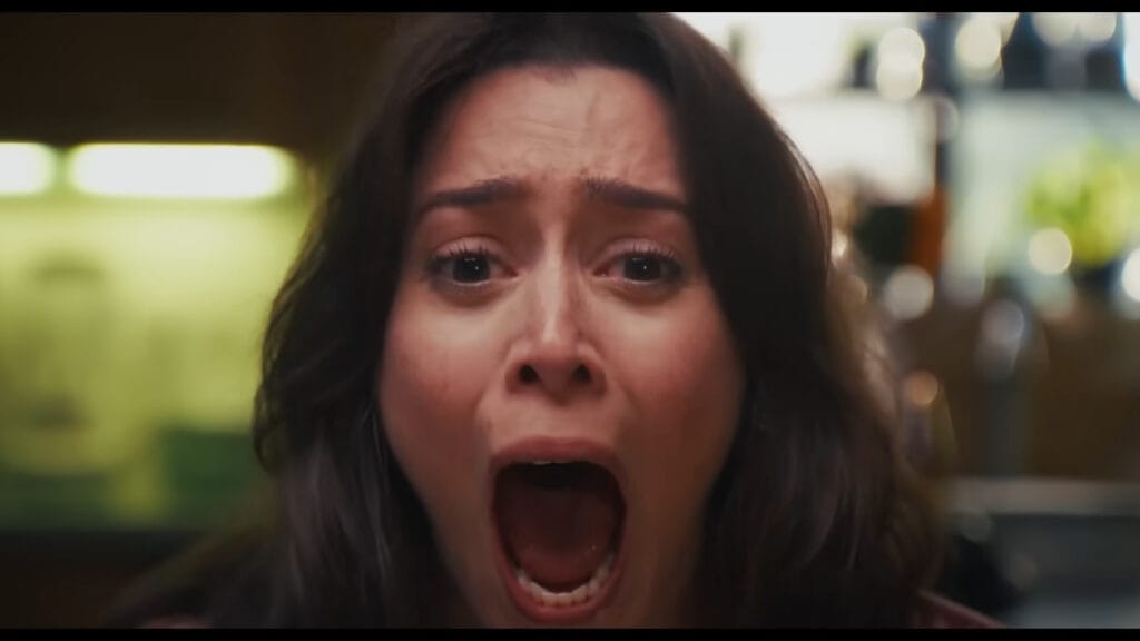 A close-up shot of a terrified woman screaming in horror in Buddy.