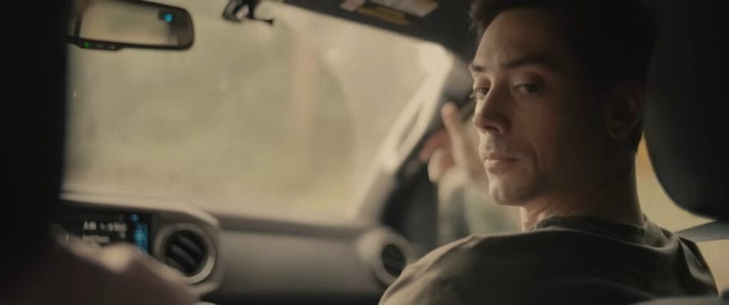 Anthony Dain looking back over his shoulder from the front seat of a car in Deathwoods.