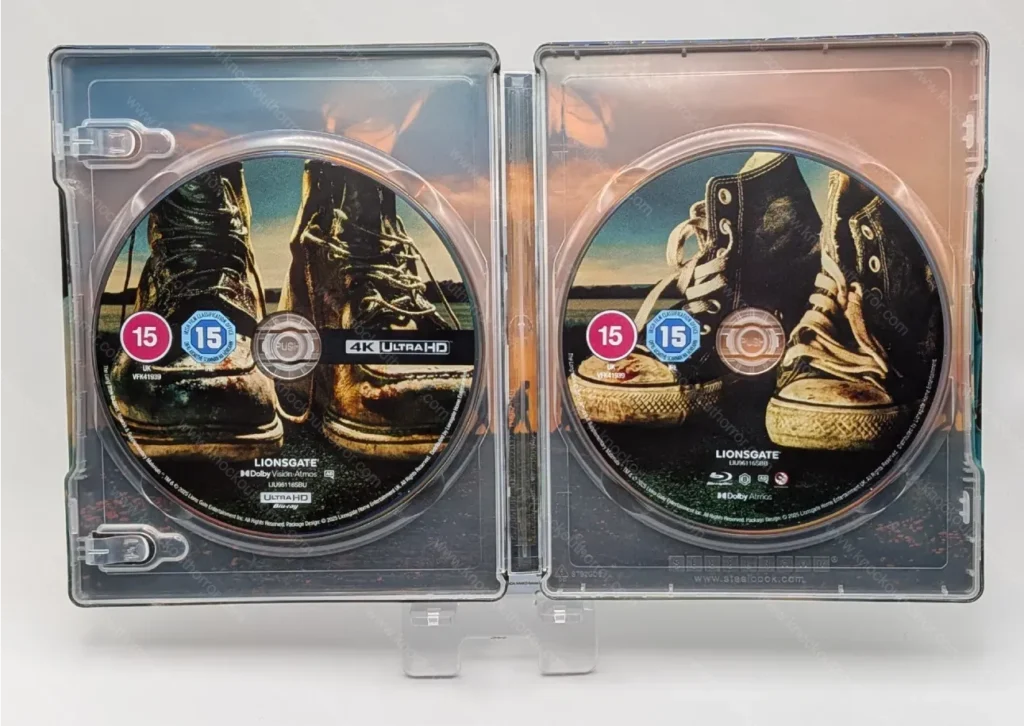Open interior of The Long Walk 4K steelbook displaying the 4K UHD and Blu-ray discs featuring combat boot and Chuck Taylor Converse artwork.