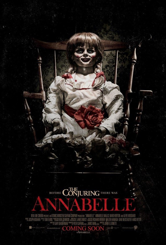 Official movie poster for Annabelle featuring the vintage porcelain doll sitting upright in a wooden rocking chair.