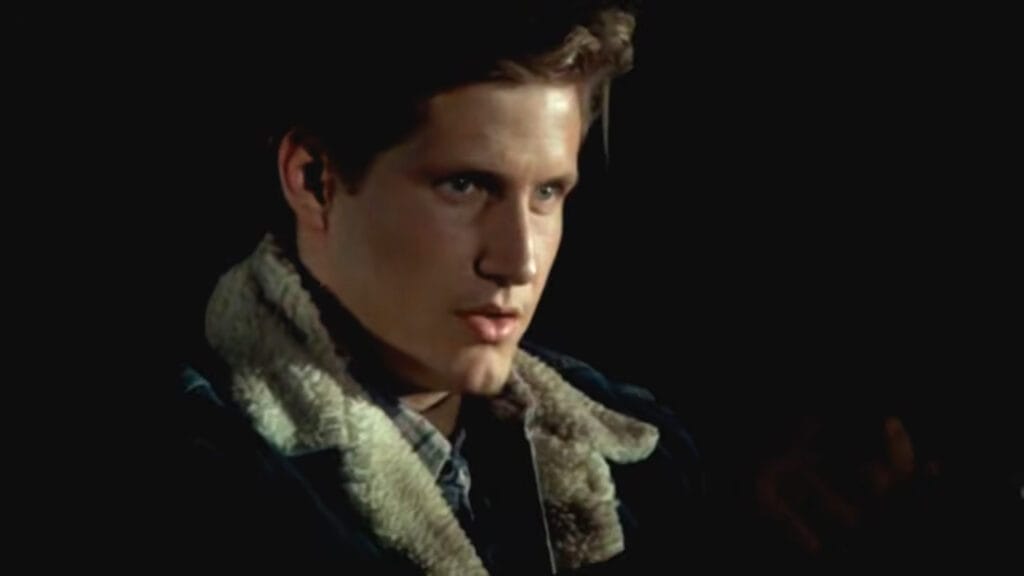 Thom Mathews as Tommy Jarvis looking intensely into the shadows wearing a shearling jacket in Friday the 13th Part VI: Jason Lives.
