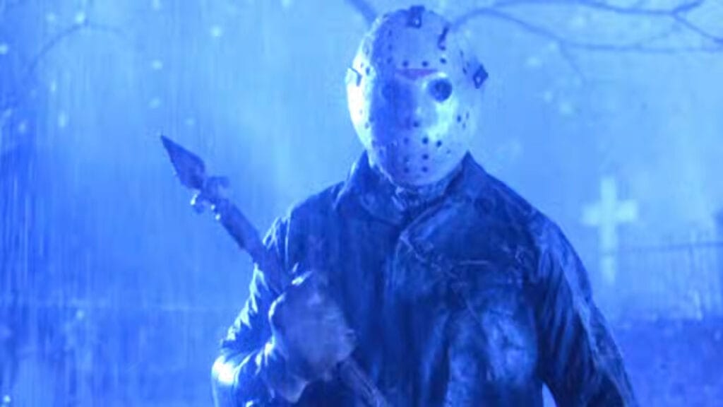 Jason Voorhees holding a rusted metal fence post under a pouring downpour in Friday the 13th Part VI: Jason Lives.