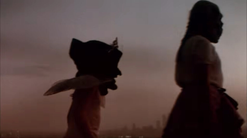 Silhouetted children wearing Halloween costumes walking at dusk in Halloween III: Season of the Witch.