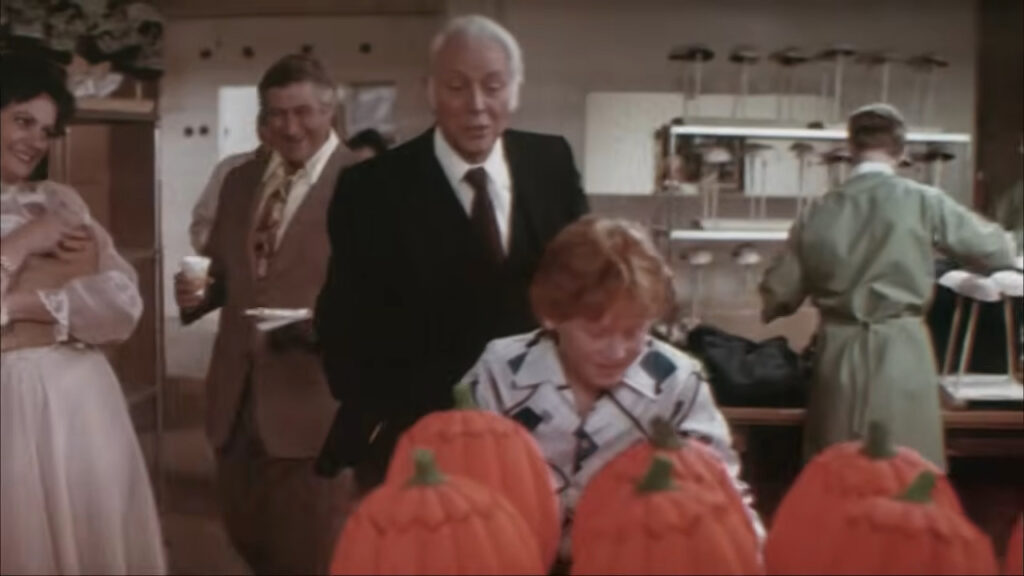 Conal Cochran giving a factory tour of the Silver Shamrock pumpkin mask workshop in Halloween III: Season of the Witch.