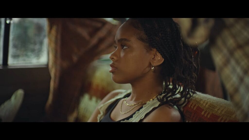 Akira Jackson looking pensively out of a car window in profile in It Ends.