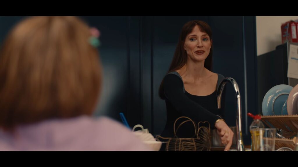 Jessica Chastain looking toward a child in a kitchen setting in Other Mommy.