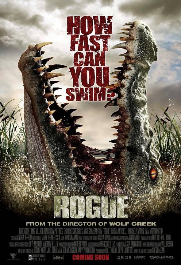 Official movie poster for Rogue featuring the massive gaping jaws of a saltwater crocodile erupting from the water.