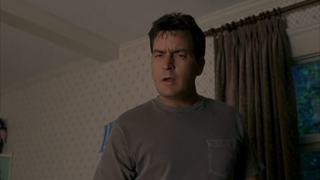 Charlie Sheen looking bewildered and puzzled inside a house in Scary Movie 3.