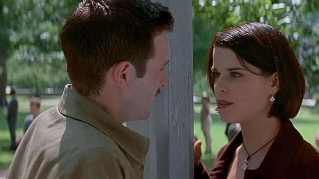 Dewey and Sidney having an emotional conversation next to a gazebo pillar on campus in Scream 2.