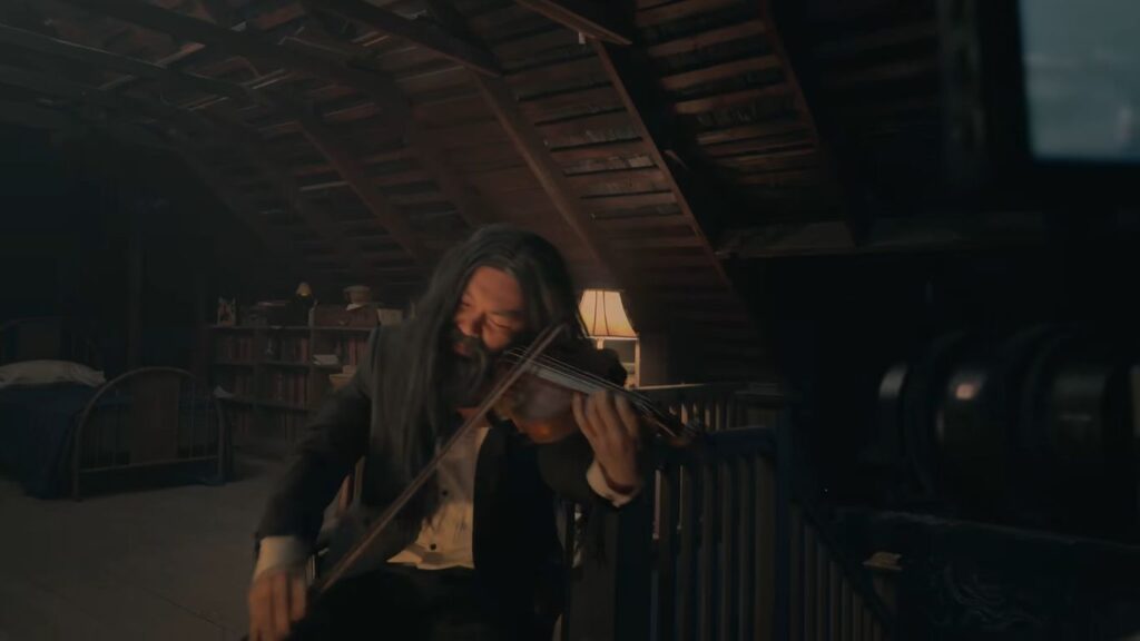 A long-haired man playing the violin intently inside a rustic attic space in V/H/S/Mixtape.